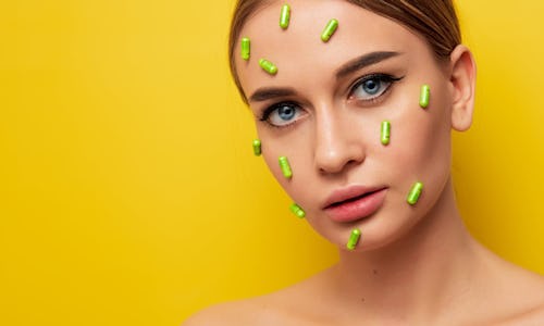 Picture of a lady with tablet pills placed on various parts of her face