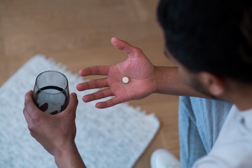 A man taking a pill