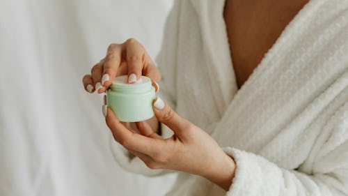 image of a woman applying a skincare moisturizing product