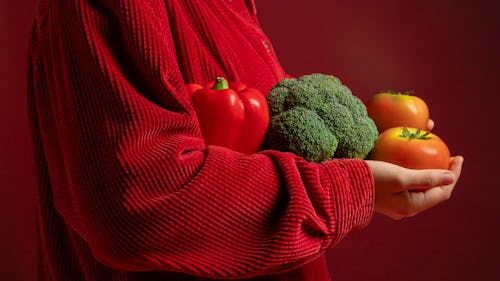 Image showing a woman holding tomatoes, red bell pepper and broccoli