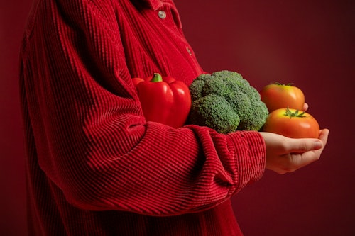 Image showing a woman holding tomatoes, red bell pepper and broccoli