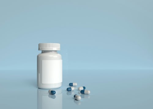 Image showing a bottle of supplement with some capsules poured out on a table