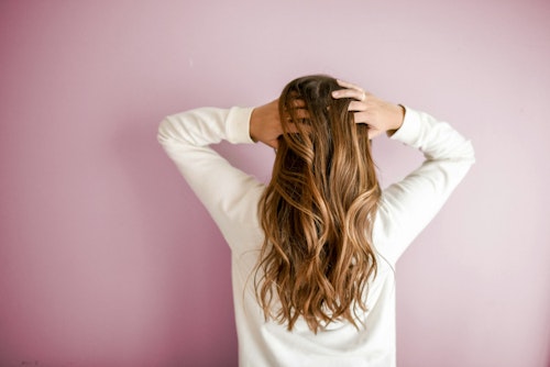 Image of a girl showing off her long blonde hair