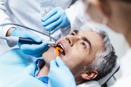 A man in a dentist's office receiving dental care