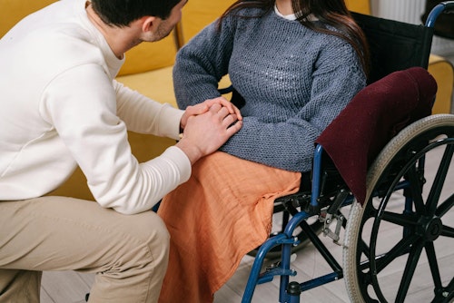 A woman with a disabling medical condition on a wheelchair