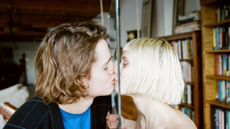 A man and a woman kissing before having oral sex