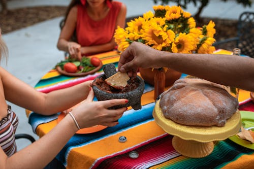 People eating Nigerian (African) foods on a round table