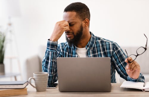 Stressed man experiencing eyes burning