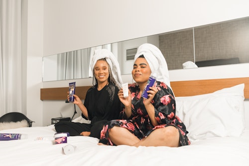 Two women holding breast enlargement creams