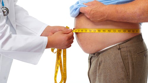 Doctor measuring a man's hip-to-waist ratio