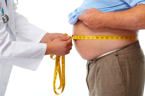 Doctor measuring a man's hip-to-waist ratio