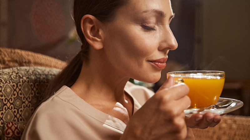 Image of a woman drinking a glass of juice