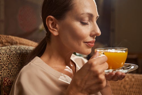 Image of a woman drinking a glass of juice