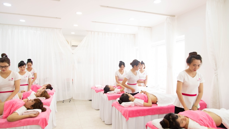 A group of massage therapists massaging women's belly