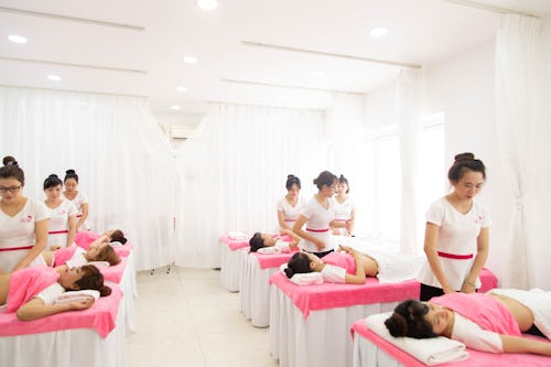 A group of massage therapists massaging women's belly