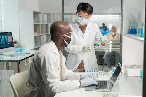 Tow laboratory scientists carrying out a test in the laboratory using samples