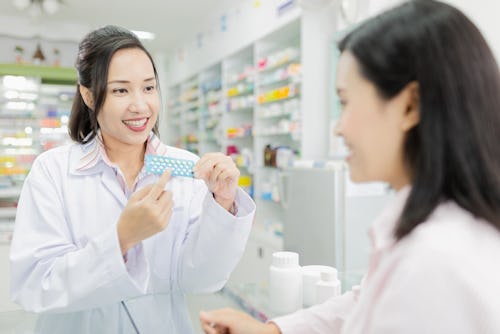 Pharmacist showing a doctor how to use contraceptive