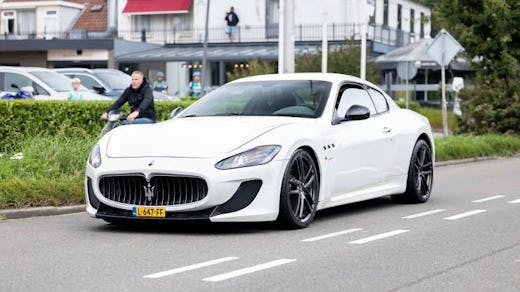 A white Maserati GranTurismo MC Stradale on the street