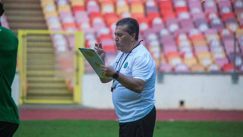 Portueguese manager, Jose Peseiro of Nigeria, takes note during training