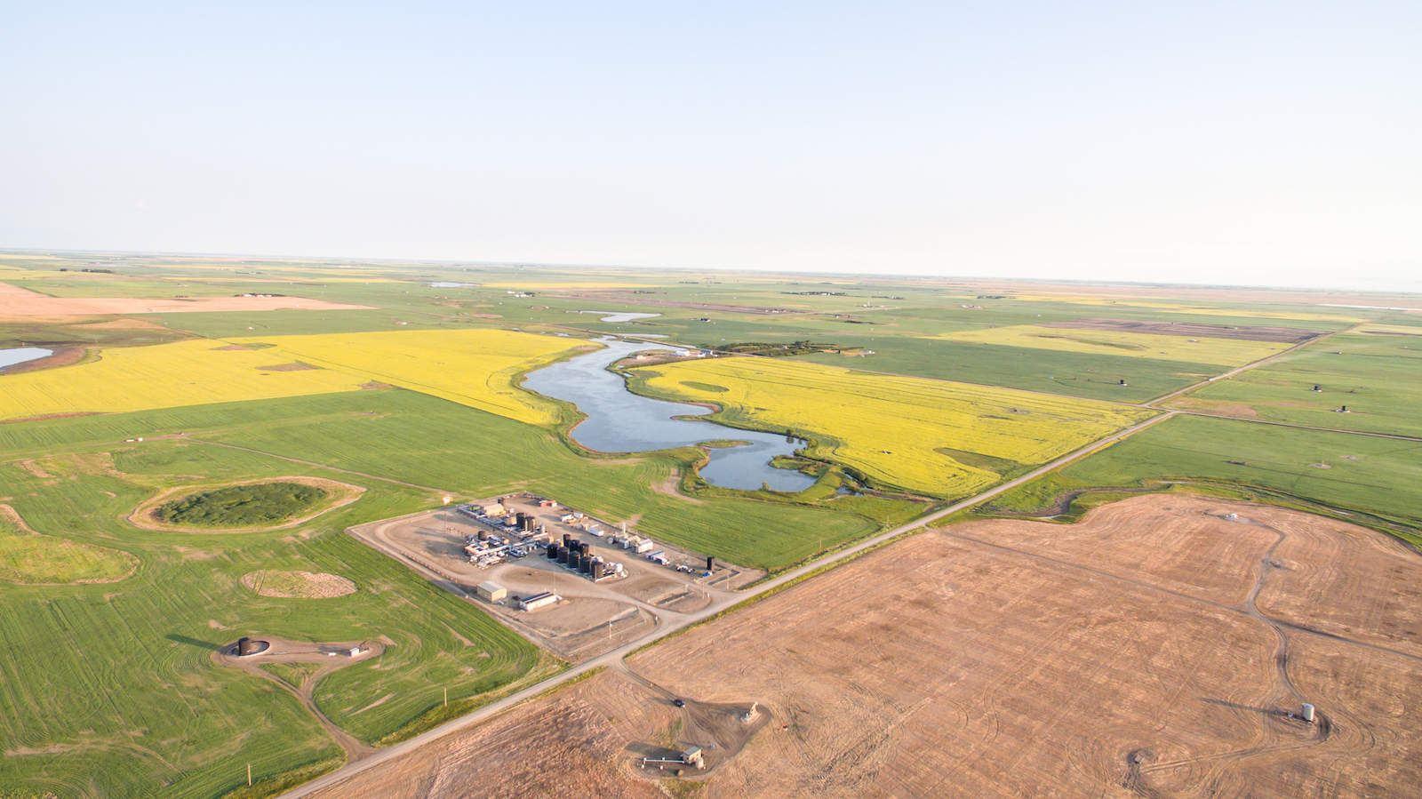 An aerial view of an oil rig and the surrounding fields.