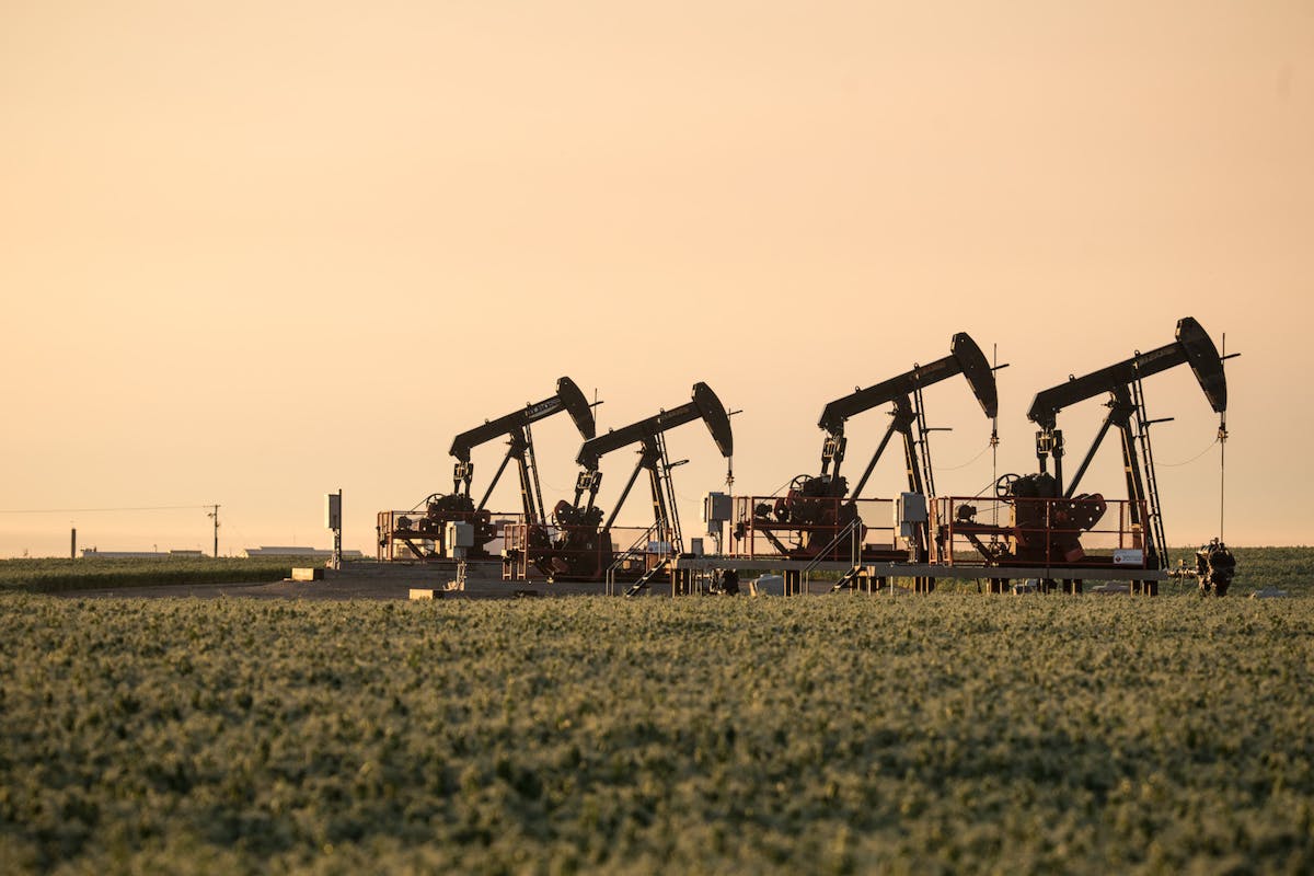 Oil machinery lit by hazy evening light.