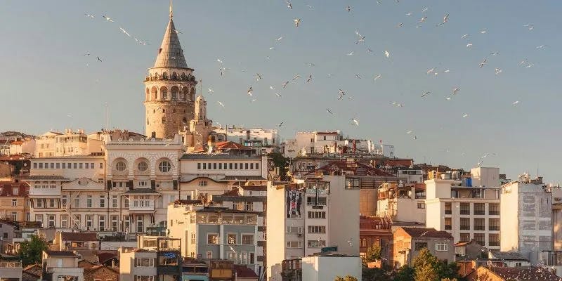 View of Galata Tower amidst residential buildings in Istanbul, Turkey, representing the destination for travelers with a Turkey sticker visa.