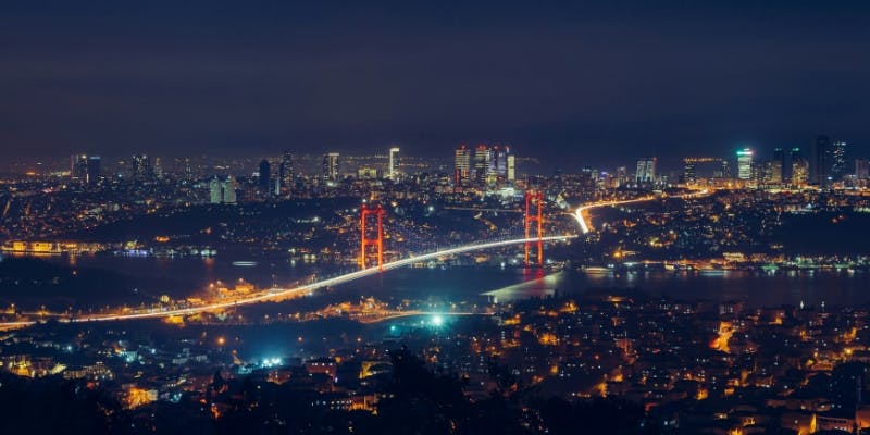 Nighttime view of the Bosphorus Bridge connecting Europe and Asia in Istanbul, a prime destination for holders of a Turkey tourist visa.