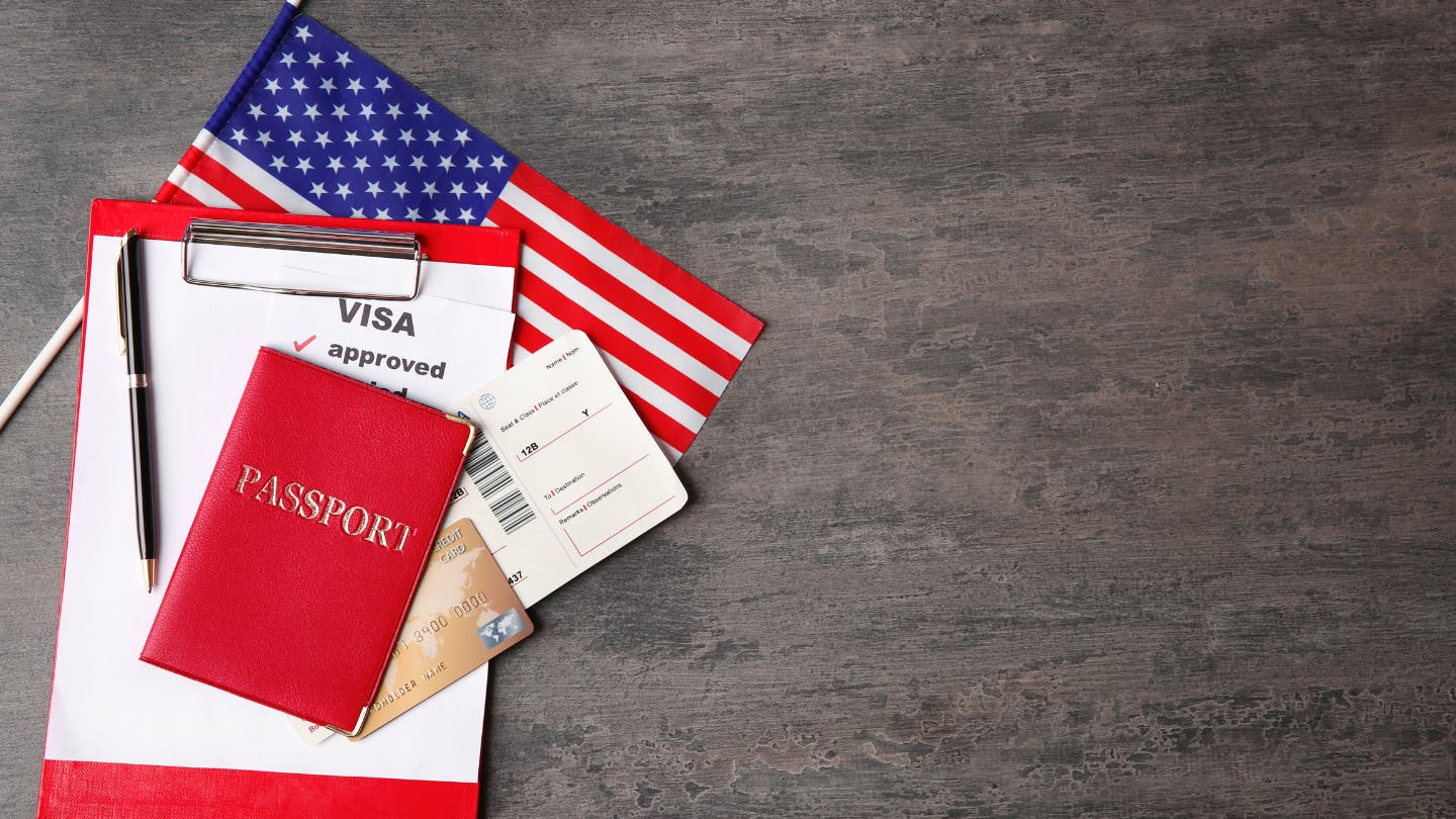 US flag and passport with approved visa