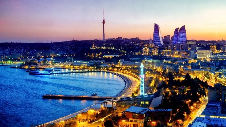 Baku skyline and waterfront at sunset.