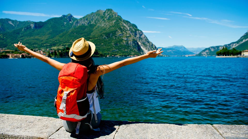 Traveler enjoying lakeside mountain view.