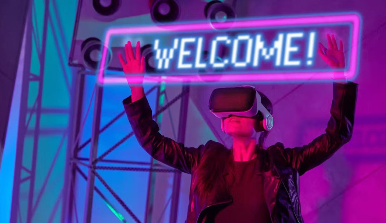 A person wearing virtual reality goggles plays with a light up "welcome" sign