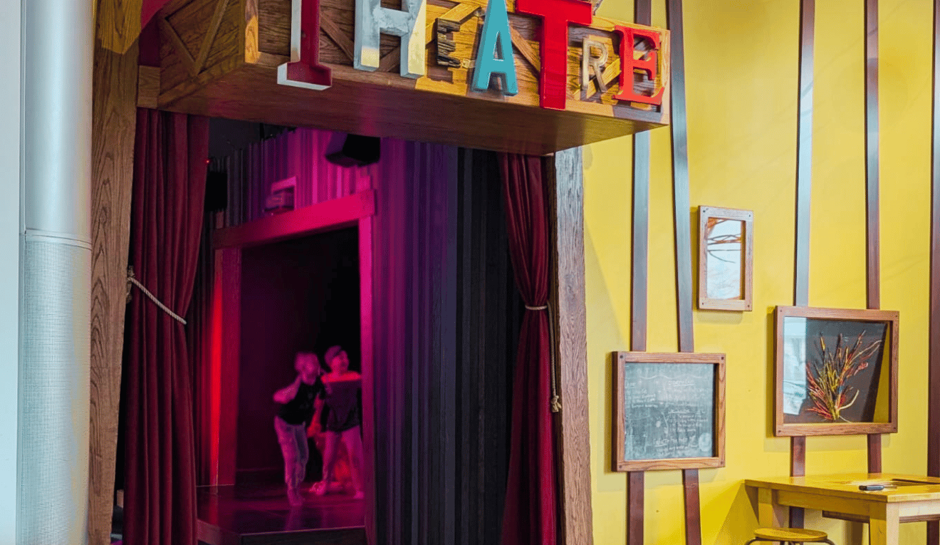 Children playing in a theatre space at Creative Kids Museum, exploring storytelling and imaginative play