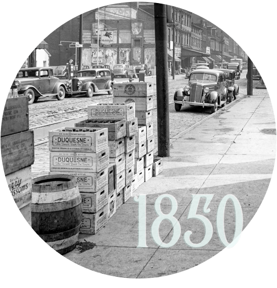strip district sidewalks with wooden boxes and barrels, and the text '1850'