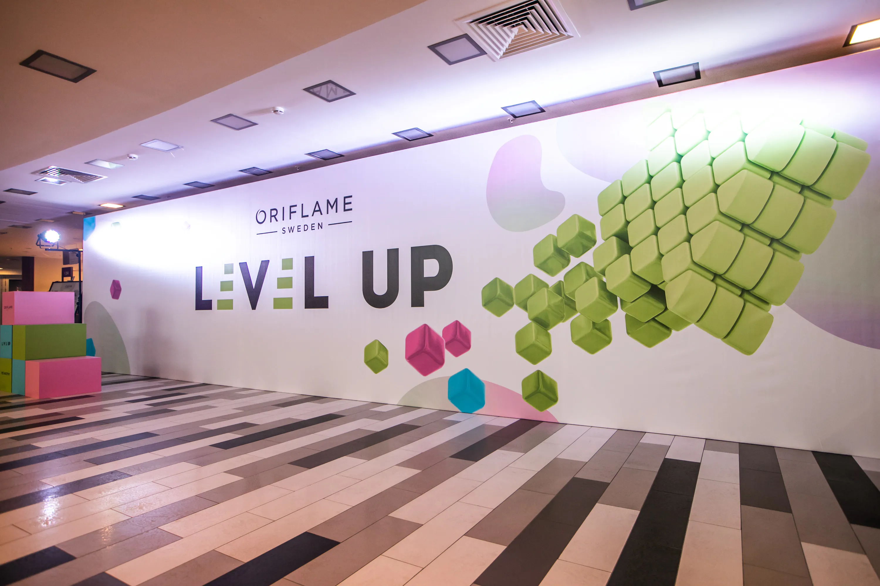 Oriflame Sweden Level Up branded wall with green 3D cubes in the venue foyer