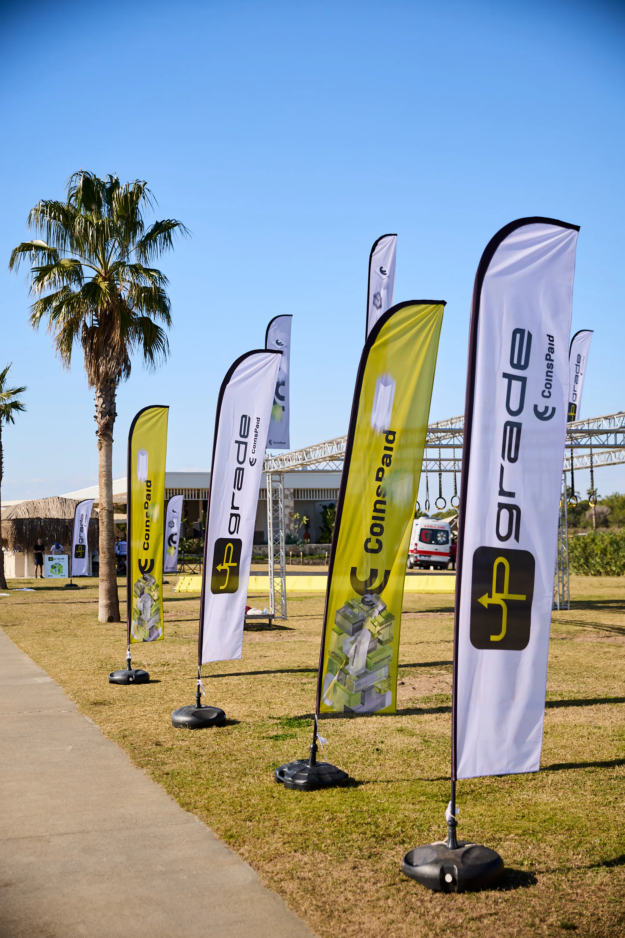 CoinsPaid and Upgrade branded flags on the lawn of the event venue in Turkey