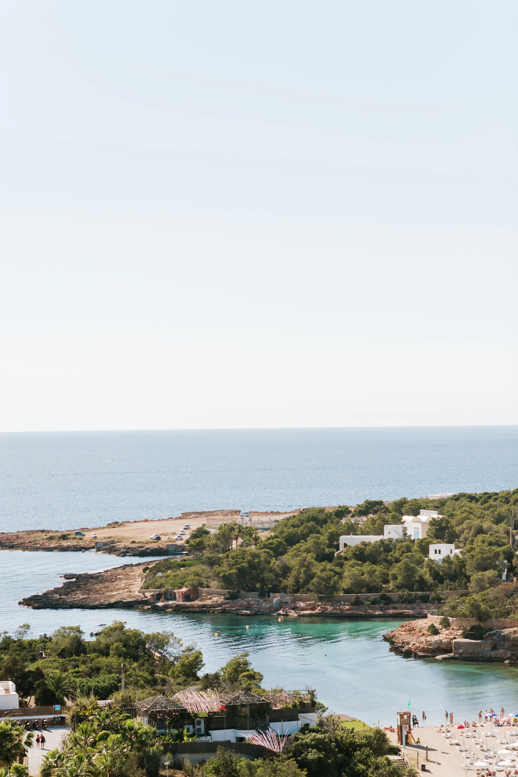 Ibiza coastline and a turquoise Mediterranean cove seen from the event venue