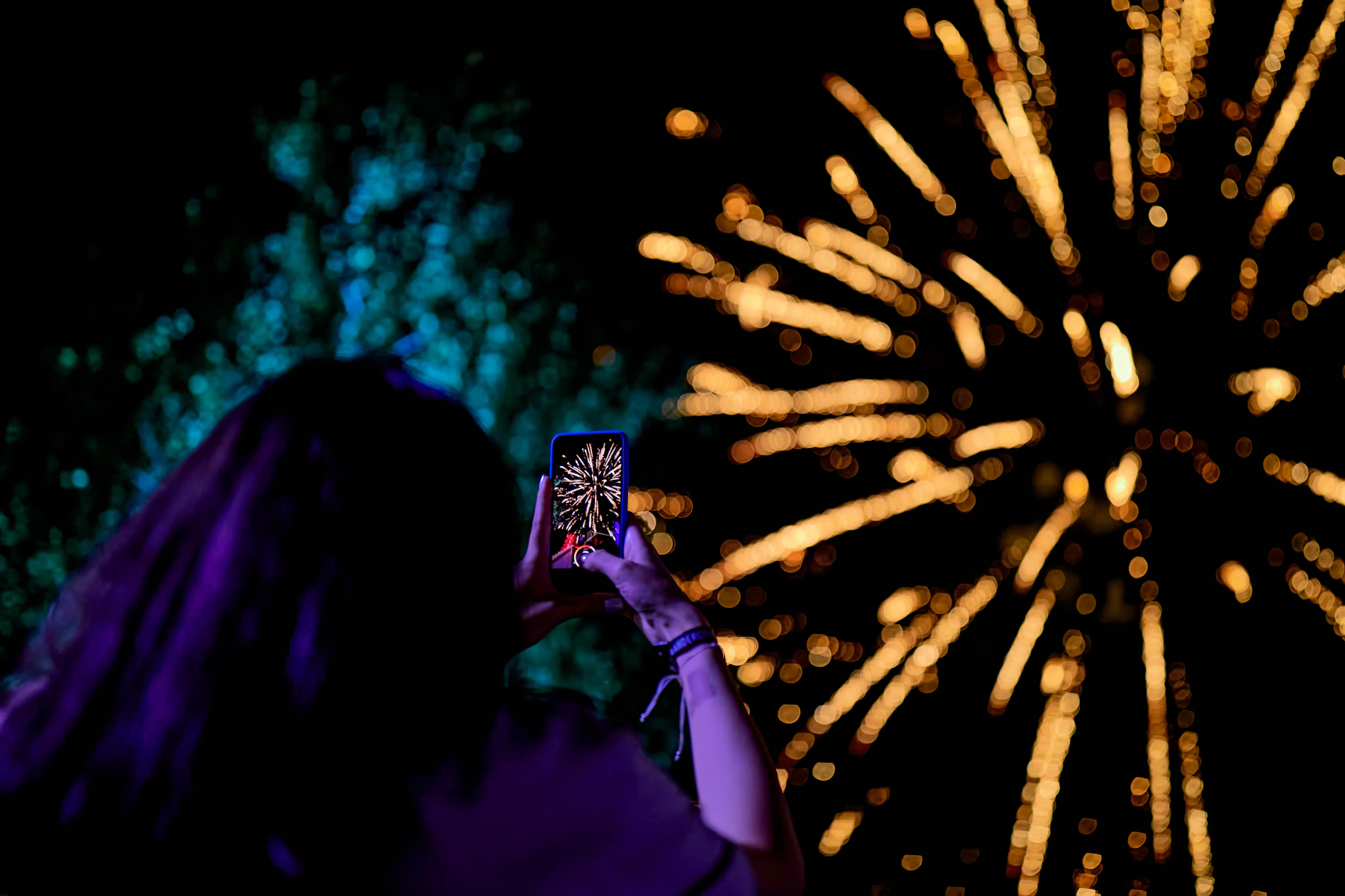 Festival guest filming the fireworks on a smartphone during the Andersen Summer Festival night show