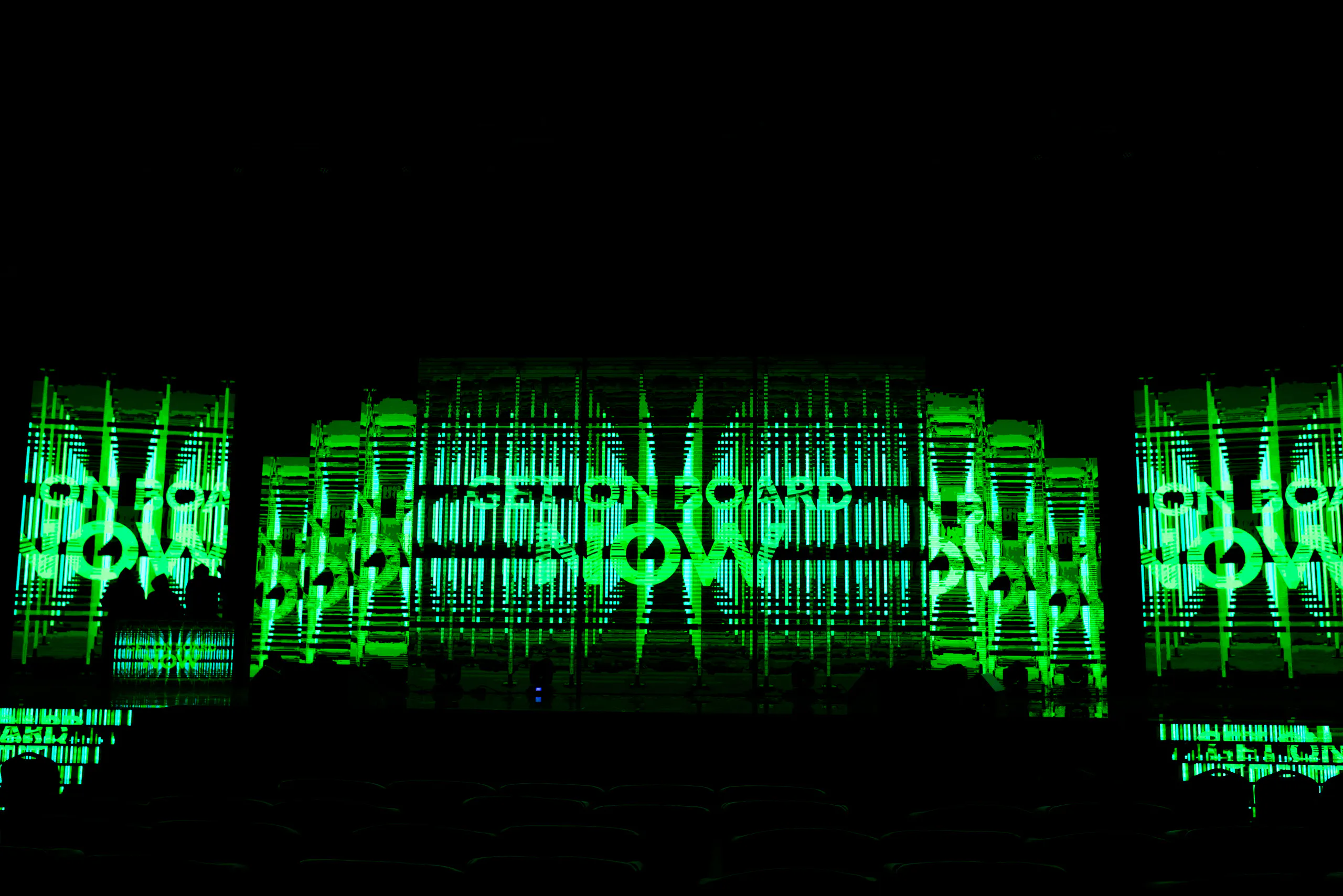 LED stage wall displaying "Get on board now" in green animated graphics at the Oriflame Summit