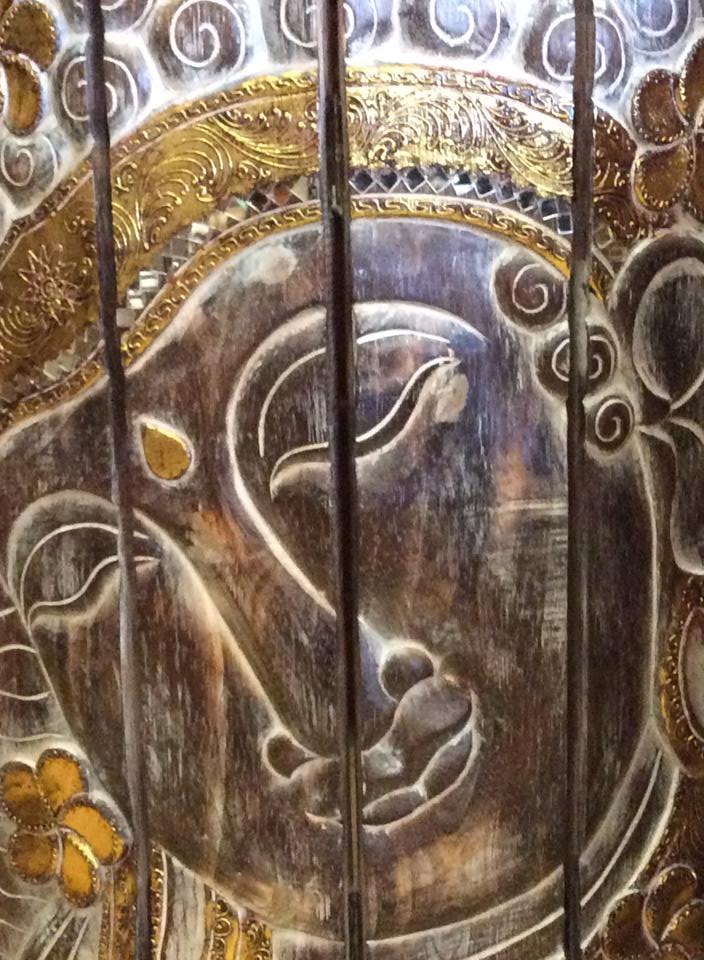 Wooden panel with Buddha face