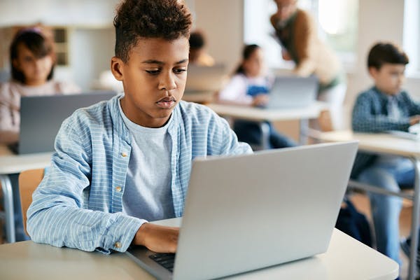 Student using laptop classroom