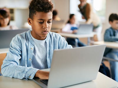 Student using laptop classroom