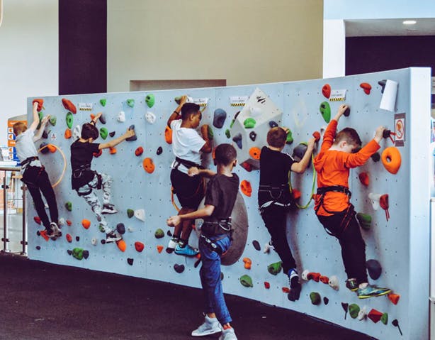 Students climbing on a rock climbing wall