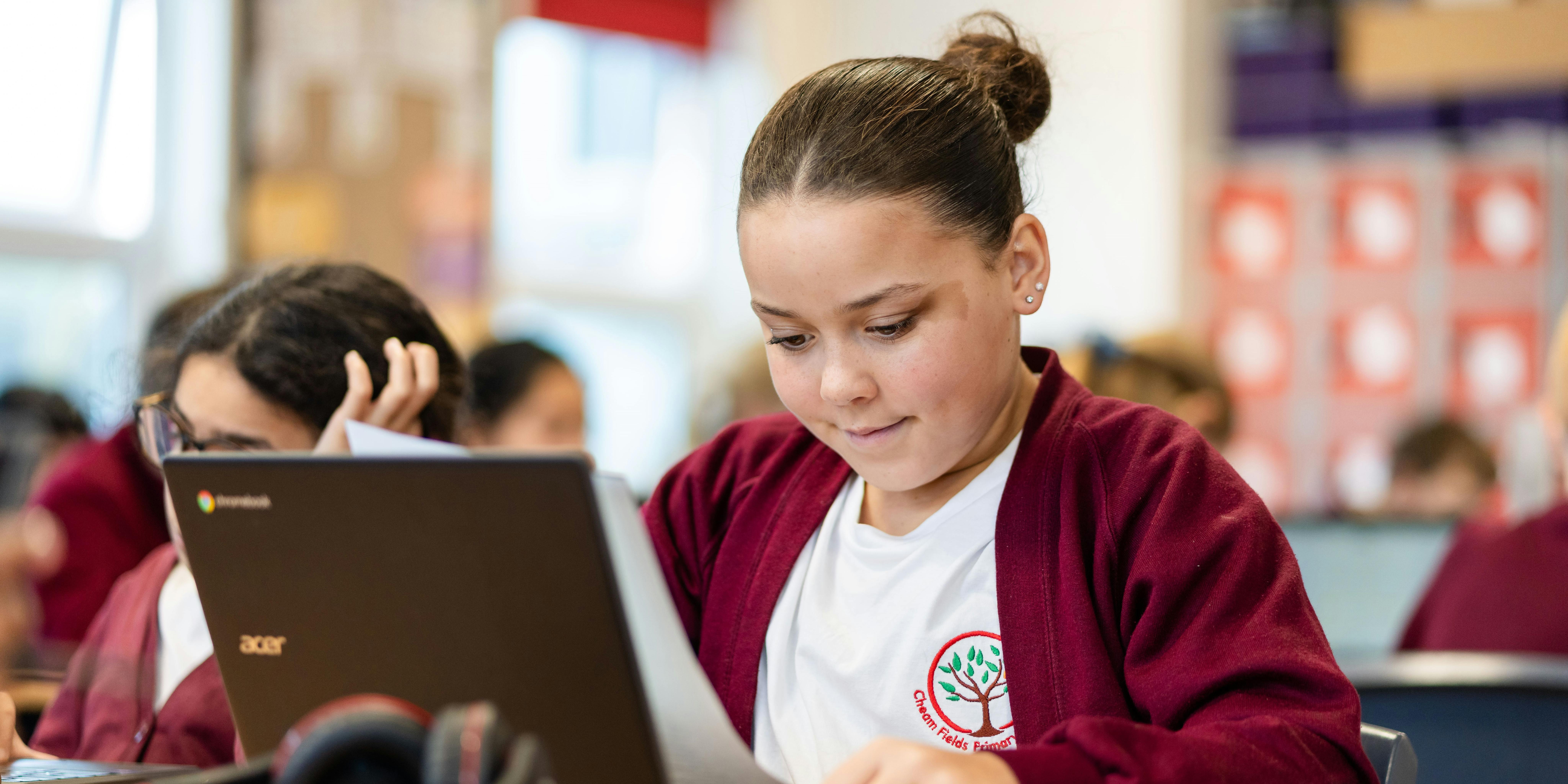 Primary age student using laptop