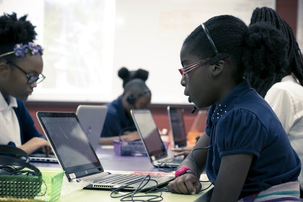 Students in a classroom working on laptops