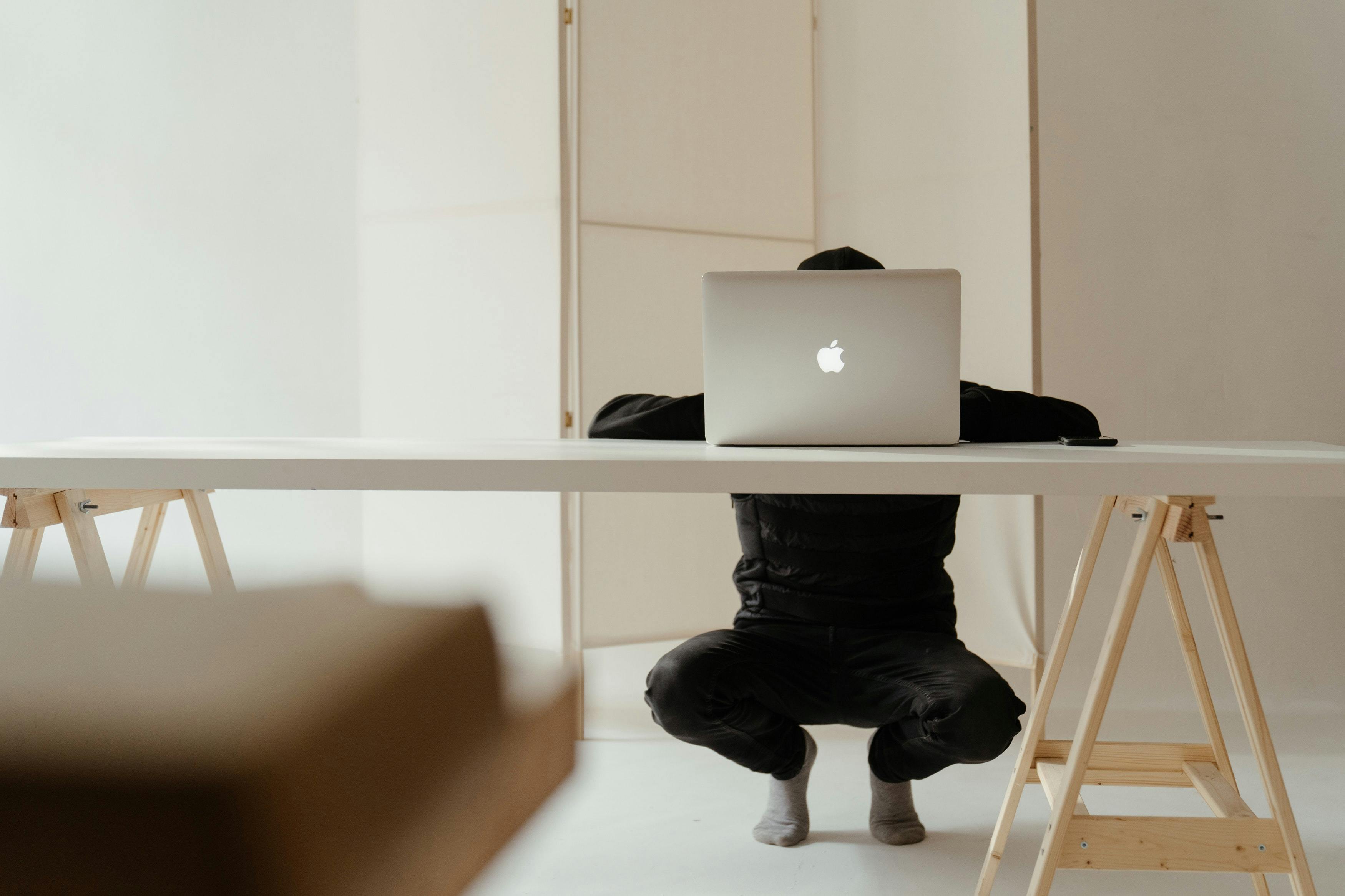 a person is working on his laptop, in a minimalist room