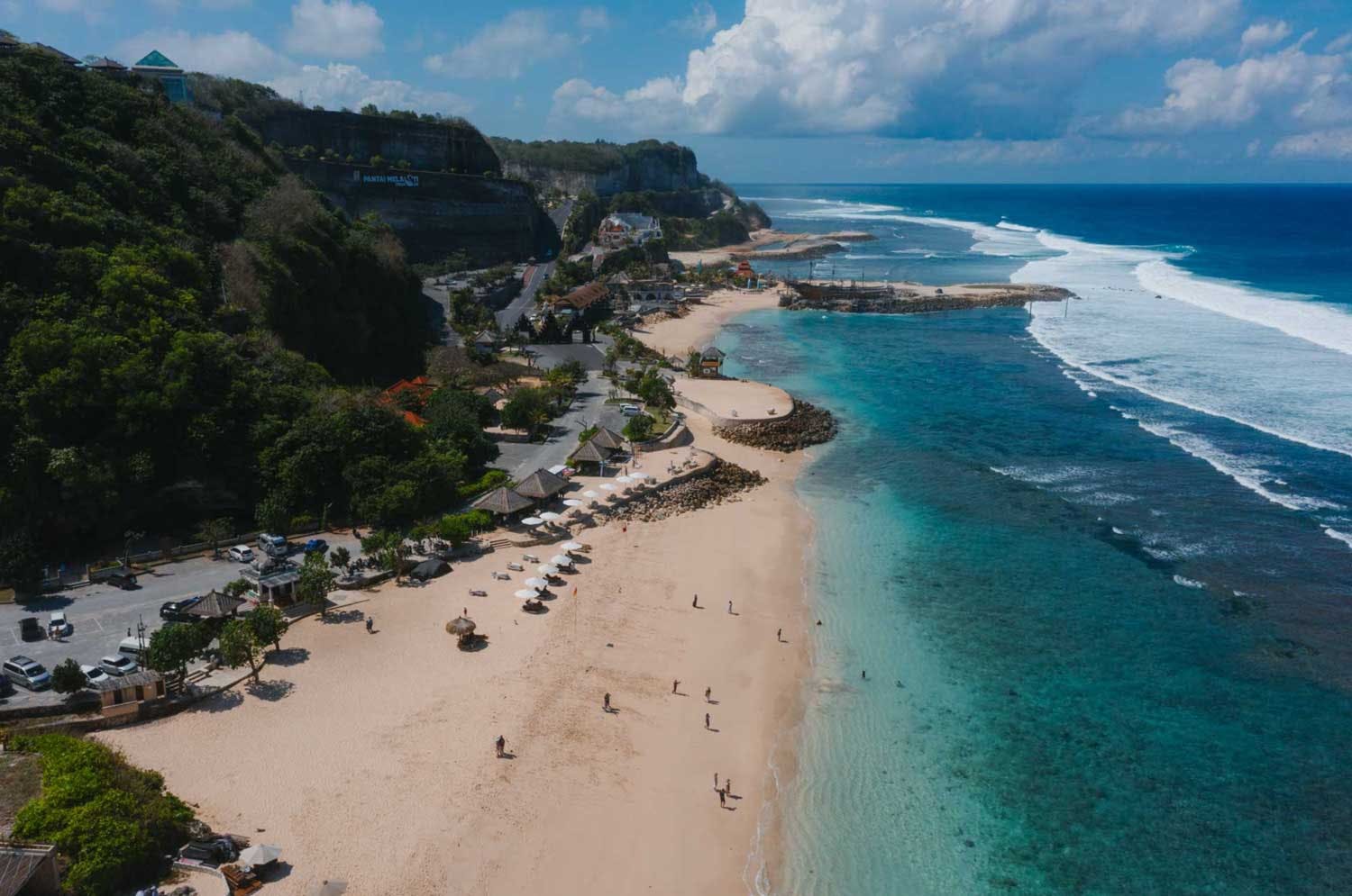 A beautiful white sand beach with crystal-clear waters, perfect for sunbathing or swimming.