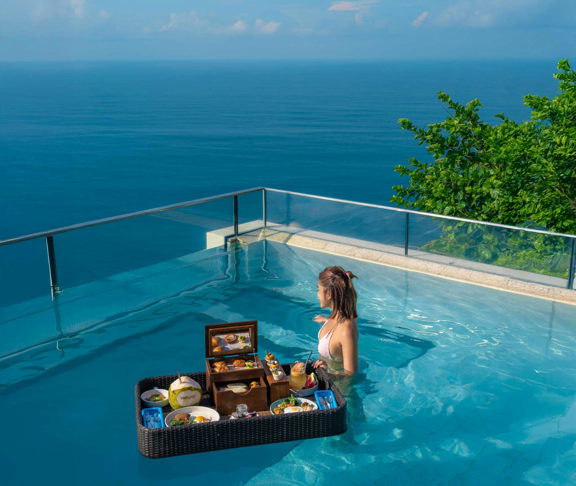 amazing floating breakfast experience set in a glass-bottom sky pool, perched on a cliff in Uluwatu, with breathtaking ocean views