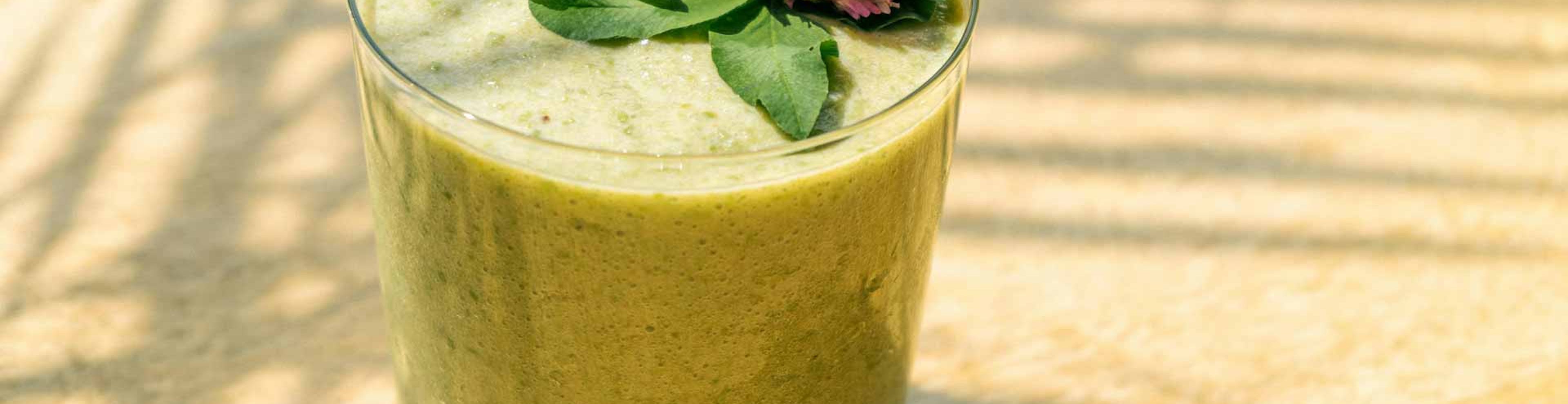 green smoothie with flower on top