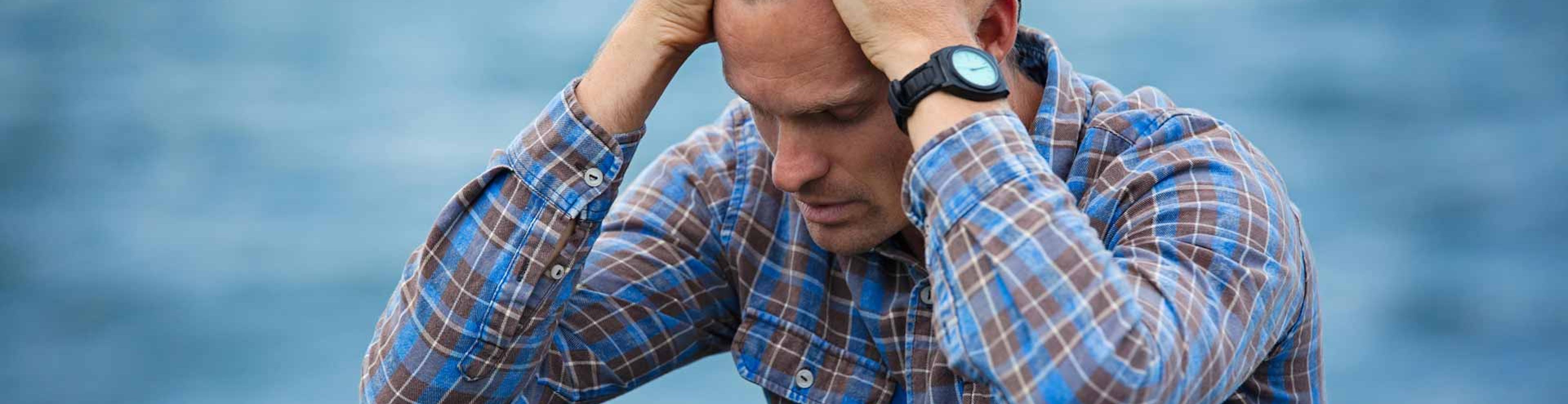 man with hands on head