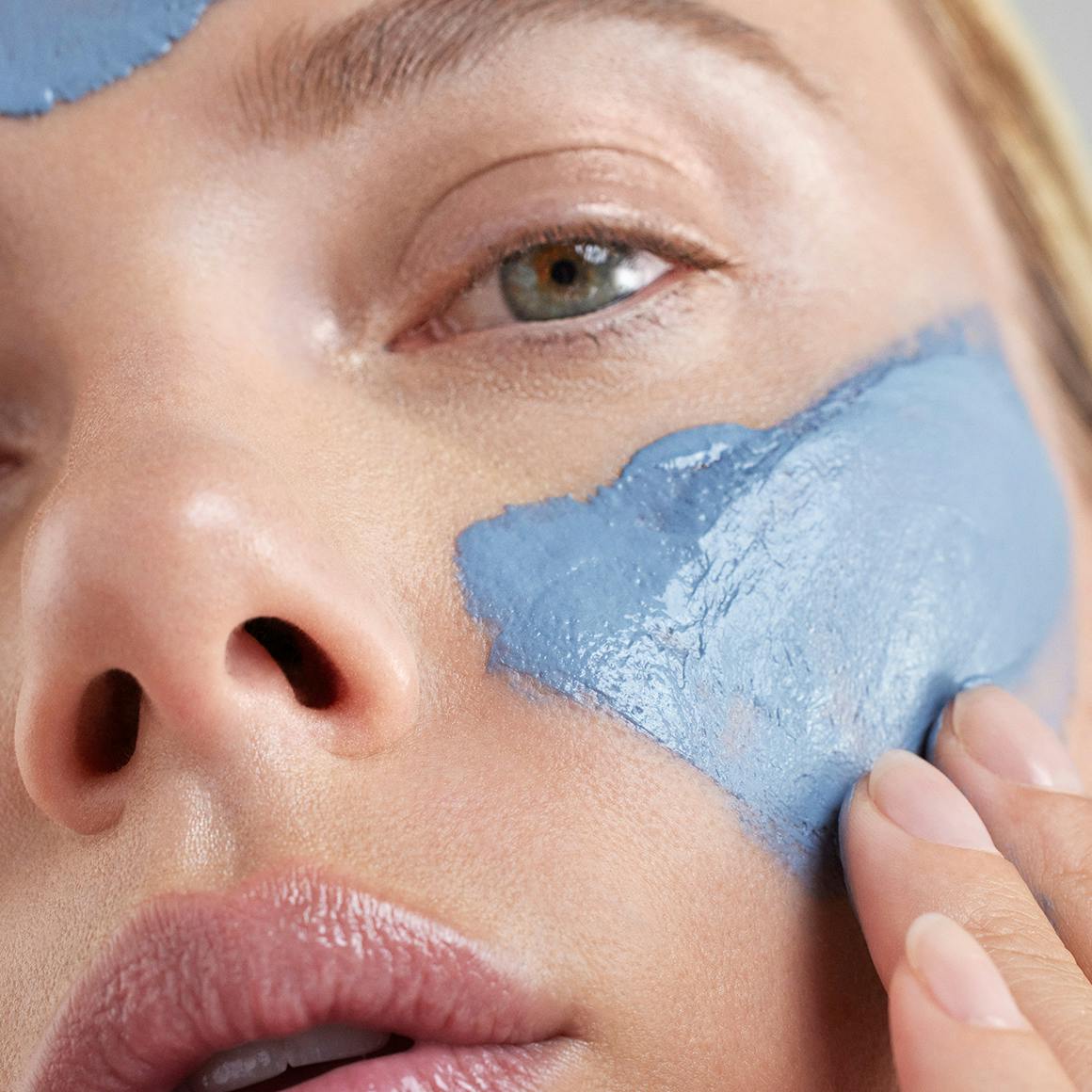 Photo of Scarlett Johansson applying The Outset's Purifying Blue Clay Mask